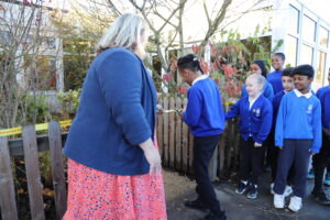 Viking Primary School pupil cutting the ribbon to mark the grand opening the Place2Be Securing Tomorrow Garden