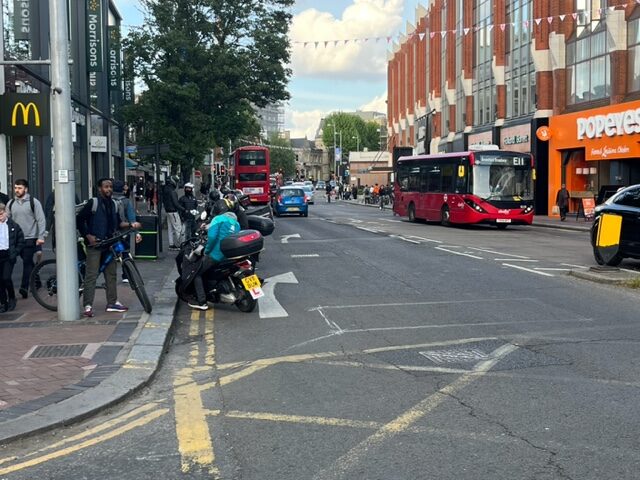 Delivery drivers parked on double yellow lines and bus and cycling lane in Ealing Broadway outside McDonalds