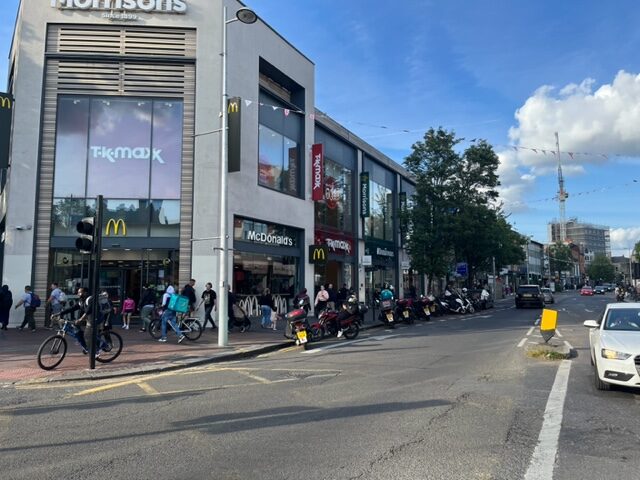 Delivery drivers parked on double yellow lines and bus and cycling lane in Ealing Broadway outside McDonalds