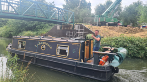 First boat under new bridge for Grand Union Canal between Marnham Fields (Greenford) and Smiths Farm (Northolt). Photo: Friends of Grand Union Canal