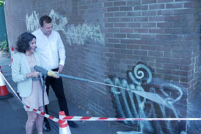 Councillor Peter Mason and Councillor Deirdre Costigan clearing graffiti. Photo: Ealing Council