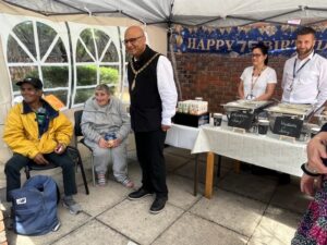 Mayor of Ealing, Councillor Hitesh Tailor with local people at pop up soup kitchen at Clayponds