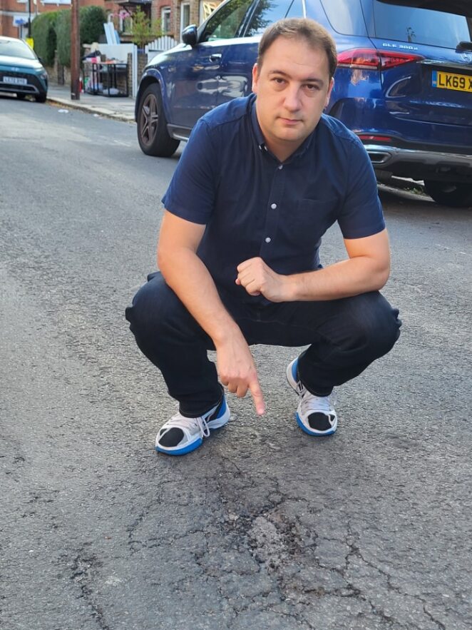Councillor Gary Busuttil showing potholes on Fletcher Road