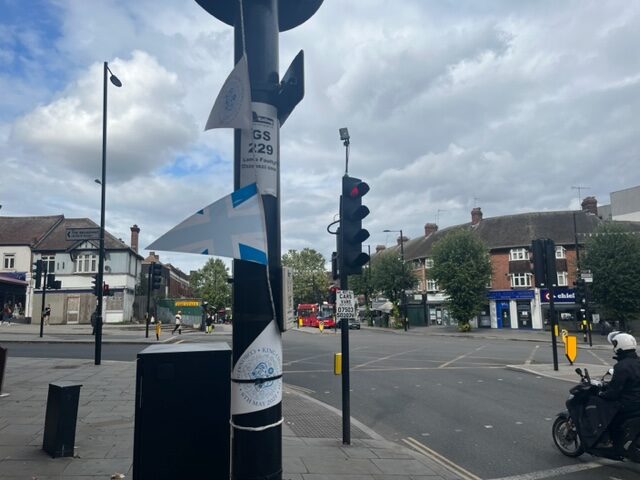 Faded King Charles III Coronation bunting left up in Greenford Broadway. Photo: EALING.NEWS