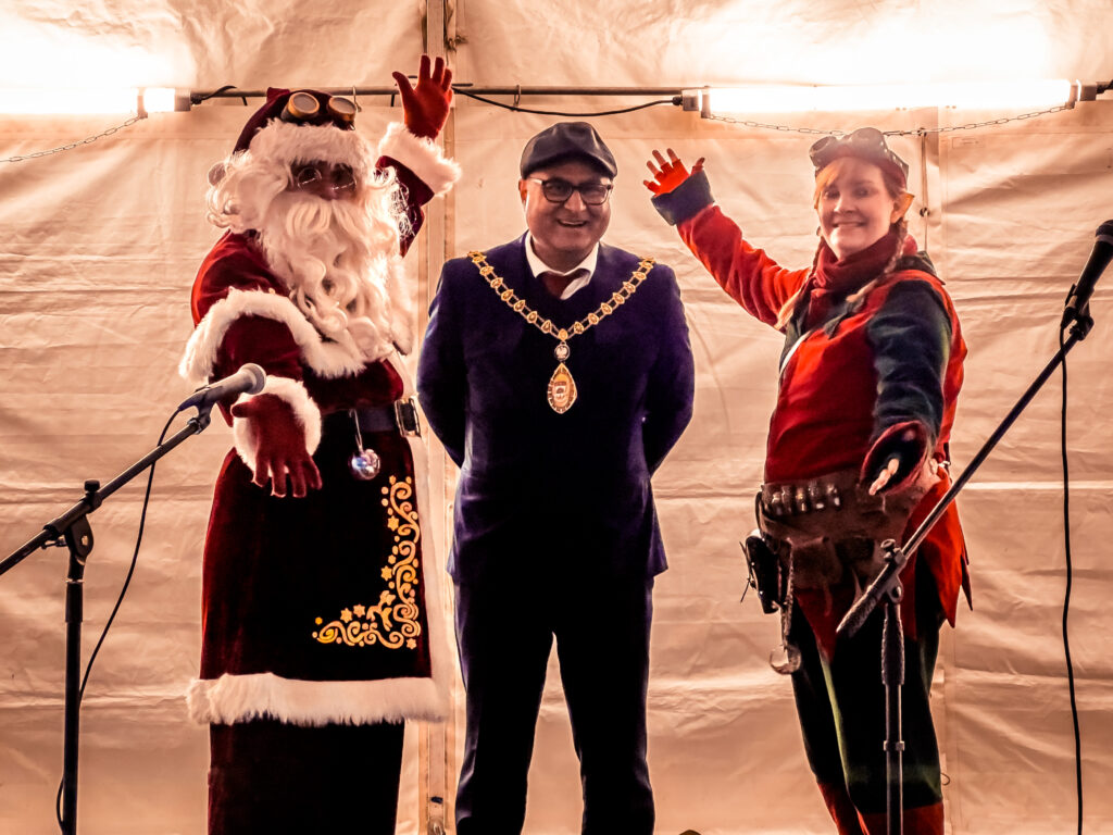 Ealing Mayor Councillor Hitesh Tailor with Santa and an Elf. Photo: Your Acton BID.