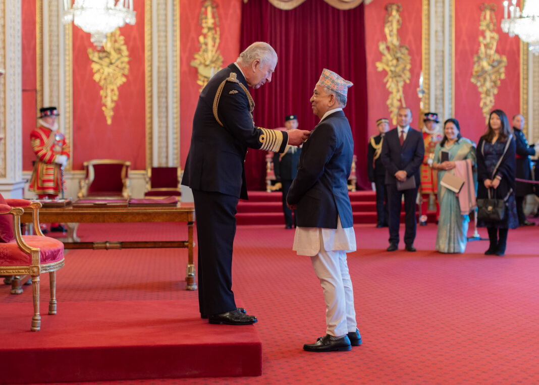 Mahanta Shrestha OBE and King Charles III at OBE investiture
