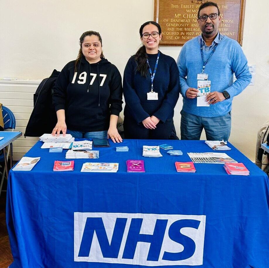 Health and Inequalities roadshow NHS stand in Northolt with Ariana Florentino Gonzalez, Abdi Ali and a volunteer.